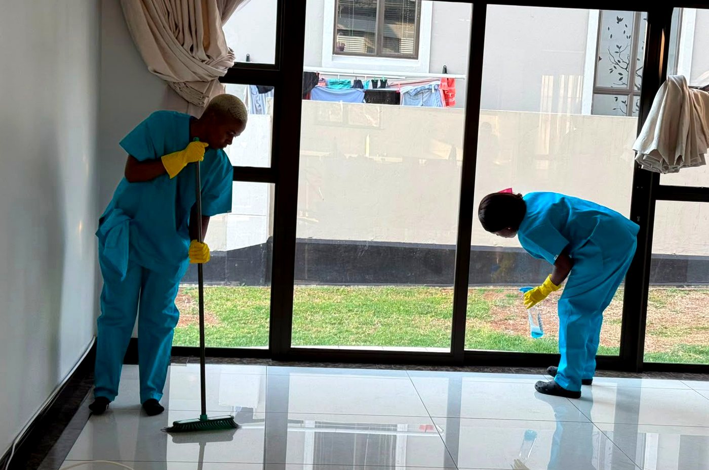 PrimeCare cleaners working on windows and interior glass